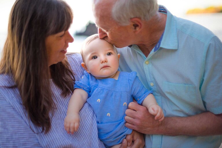 Grandparents kiss their granddaughter on Hawaii Island