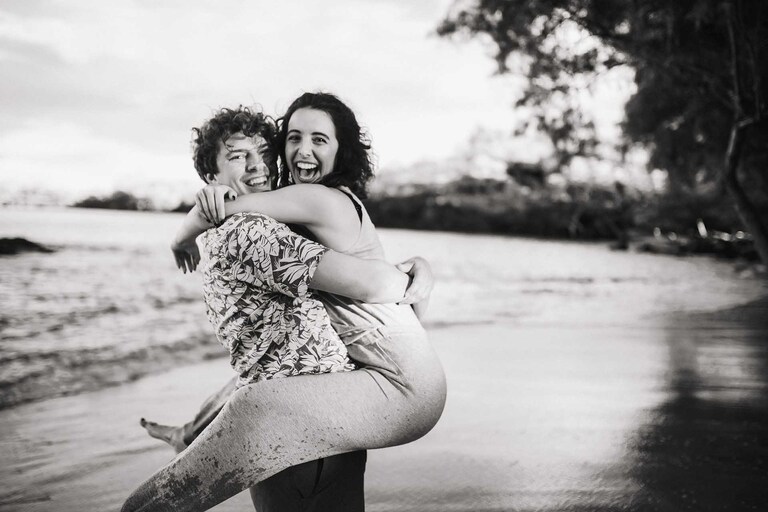 A couple embracing on a beach near Kona, Hawaii.