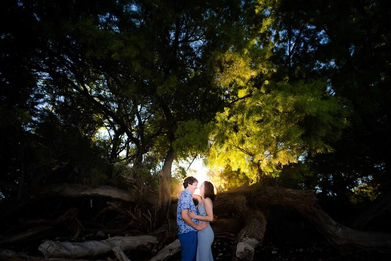 A honeymooning couple glowing in the sunrise.